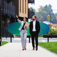 A man and a woman in formal attire outside, corporate commercial surveyors, chartered surveyors, business rates assessment